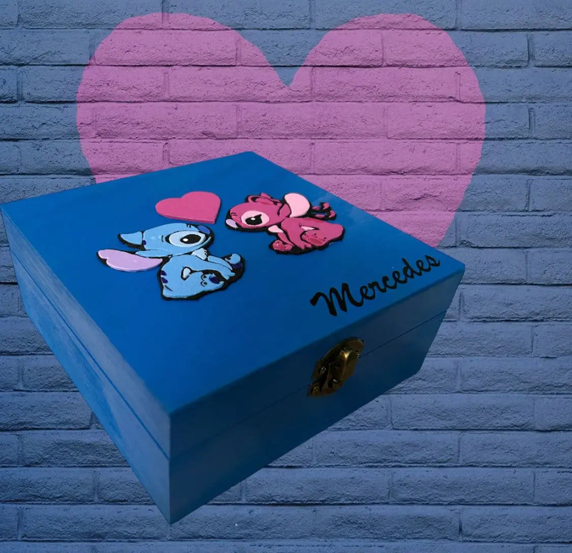 Blue hand-painted wooden customizable Stitch-themed box with pink and blue Stitch characters and personalized name "Mercedes" on the lid.