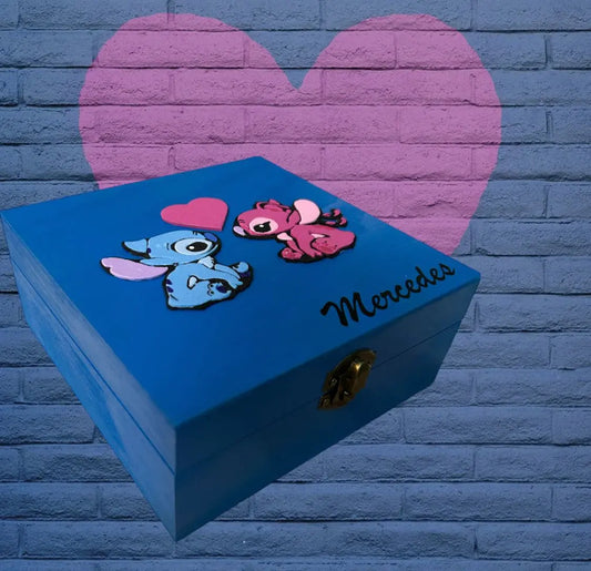 Blue hand-painted wooden customizable Stitch-themed box with pink and blue Stitch characters and personalized name "Mercedes" on the lid.