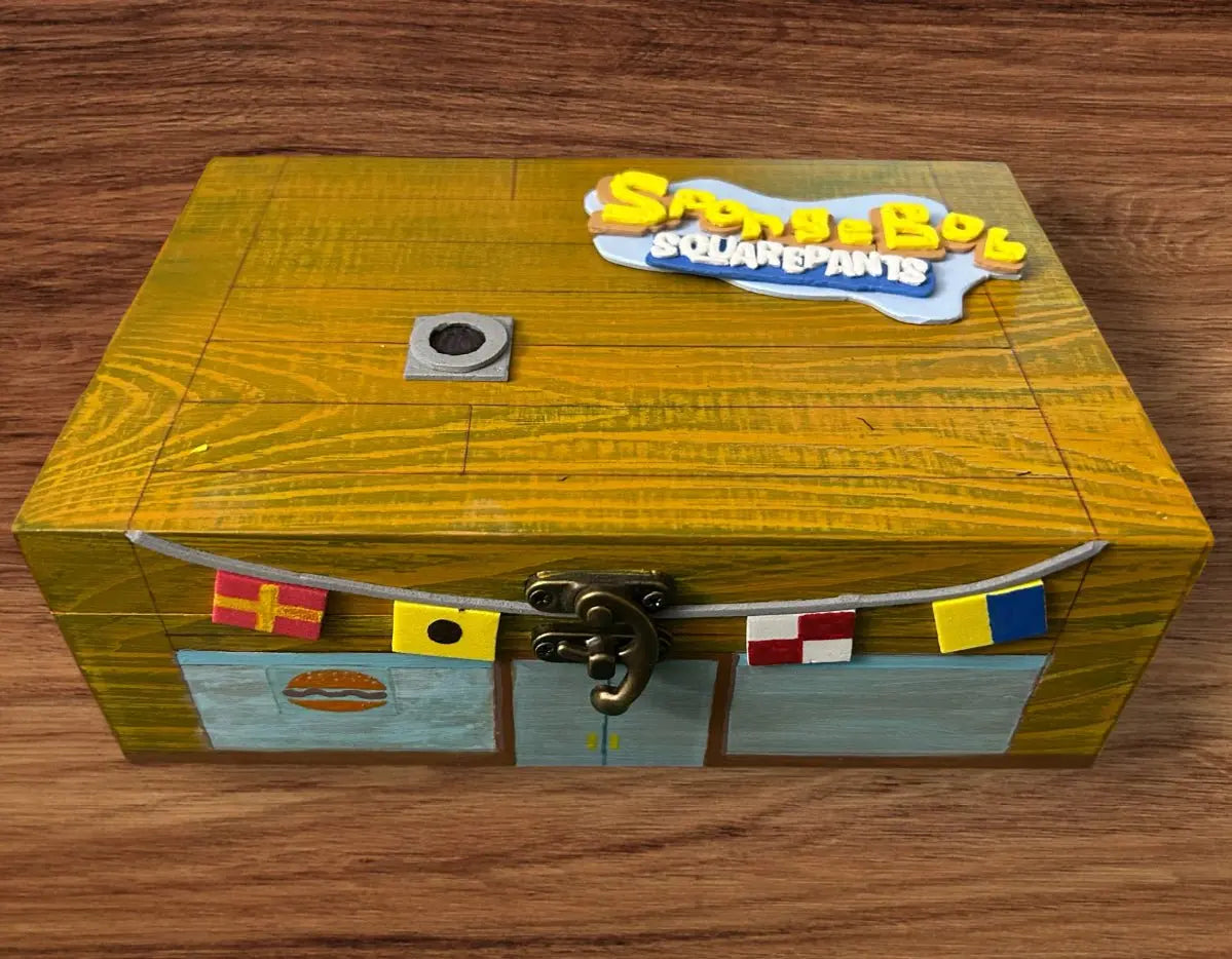 Wooden decorative SpongeBob-themed box with colorful flags and detailed hand-painted design for kids room decor and small treasure storage.